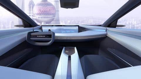 The car features a massive screen and yoke-style steering wheel