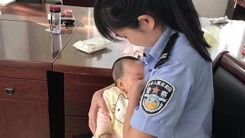 Photo of Chinese cop breastfeeding suspect's baby goes viral Photo of Chinese cop breastfeeding suspect's baby goes viral