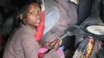 Video shows two children kneading wheat dough for midday meal
