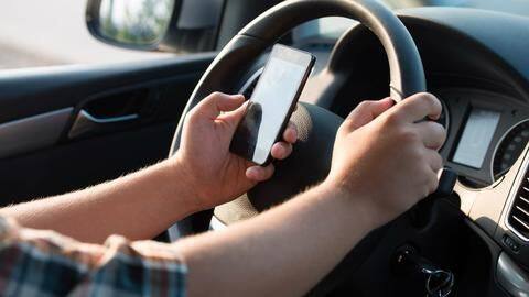 Kerala HC: Talking on phone while driving not against law Kerala HC: Talking on phone while driving not against law
