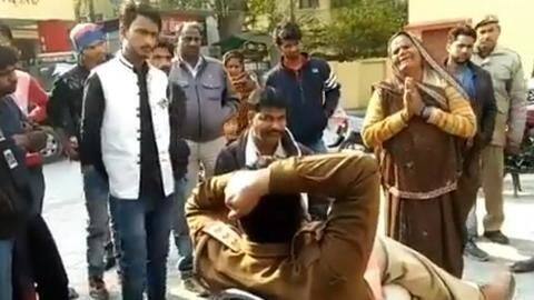 Cop transferred after video shows woman begging at his feet Cop transferred after video shows woman begging at his feet