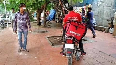 Delivery man eats food and carefully wraps it up Delivery man eats food and carefully wraps it up