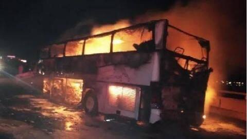 The bus was engulfed in flames, with its windows blown-out The bus was engulfed in flames, with its windows blown-out
