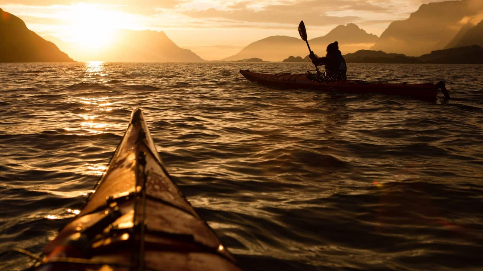 Go for a midnight sun kayaking in Lofoten, Norway