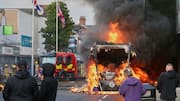 Vehicles, homes burned as anti-immigration violence flares in Northern Ireland 
