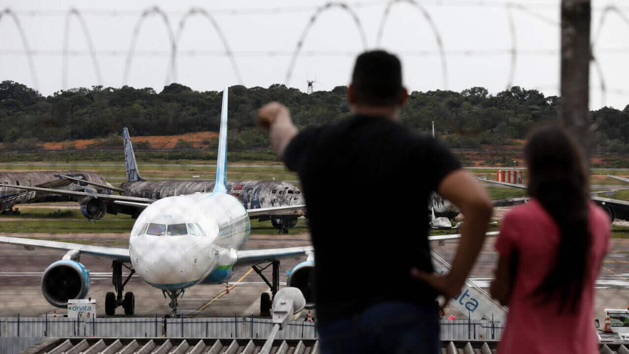 Brazilians deported from US arrive home in handcuffs, shackles