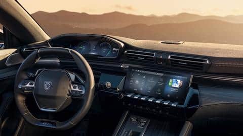 The car features the i-Cockpit infotainment system and ADAS functions
