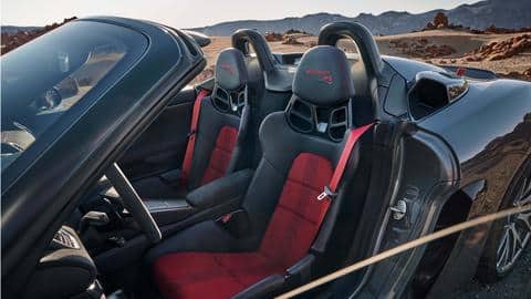 The roadster flaunts carbon fiber seats and fabric door straps
