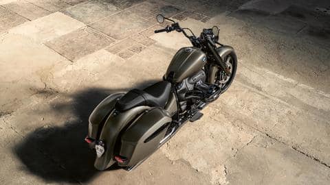 The motorcycle features a blacked-out engine with dark chrome exhaust