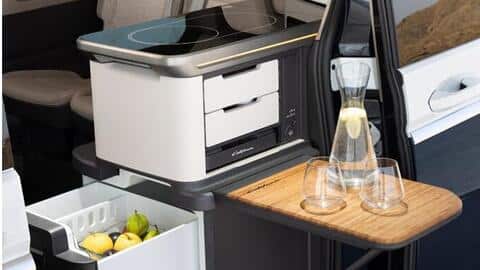 It features a compact kitchenette and a foldable table