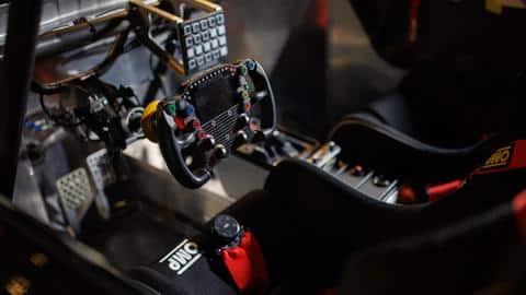It features a yoke-style steering wheel and racing-style bucket seats