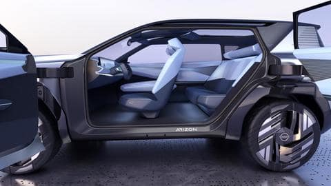 The car features a massive screen and yoke-style steering wheel
