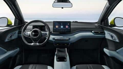 The hatchback features a rotating infotainment panel and fabric upholstery