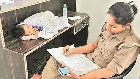 Image of 'MotherCop' with baby goes viral; time for creche-facilities? Image of 'MotherCop' with baby goes viral; time for creche-facilities?