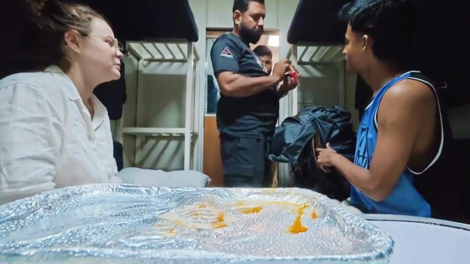 Pakistan: Officer checks woman's bag, sniffs items on train