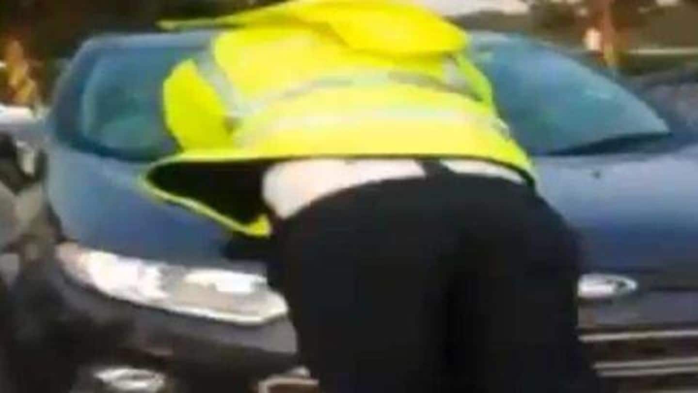 Caught-on-cam: Driver breaks rule, doesn't stop, drags traffic-cop on bonnet