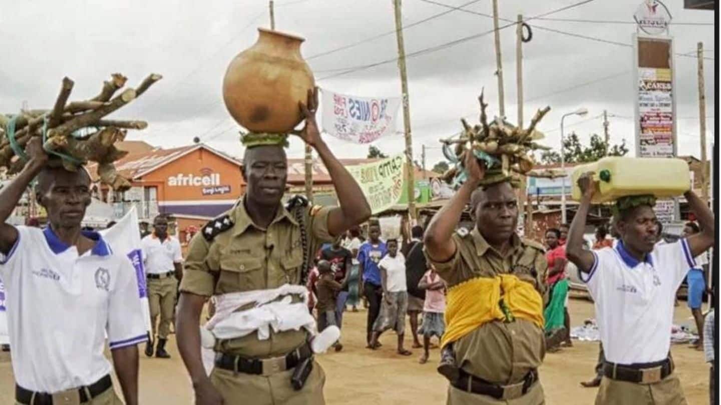 Carrying babies on back, Ugandan police-officers march against domestic violence
