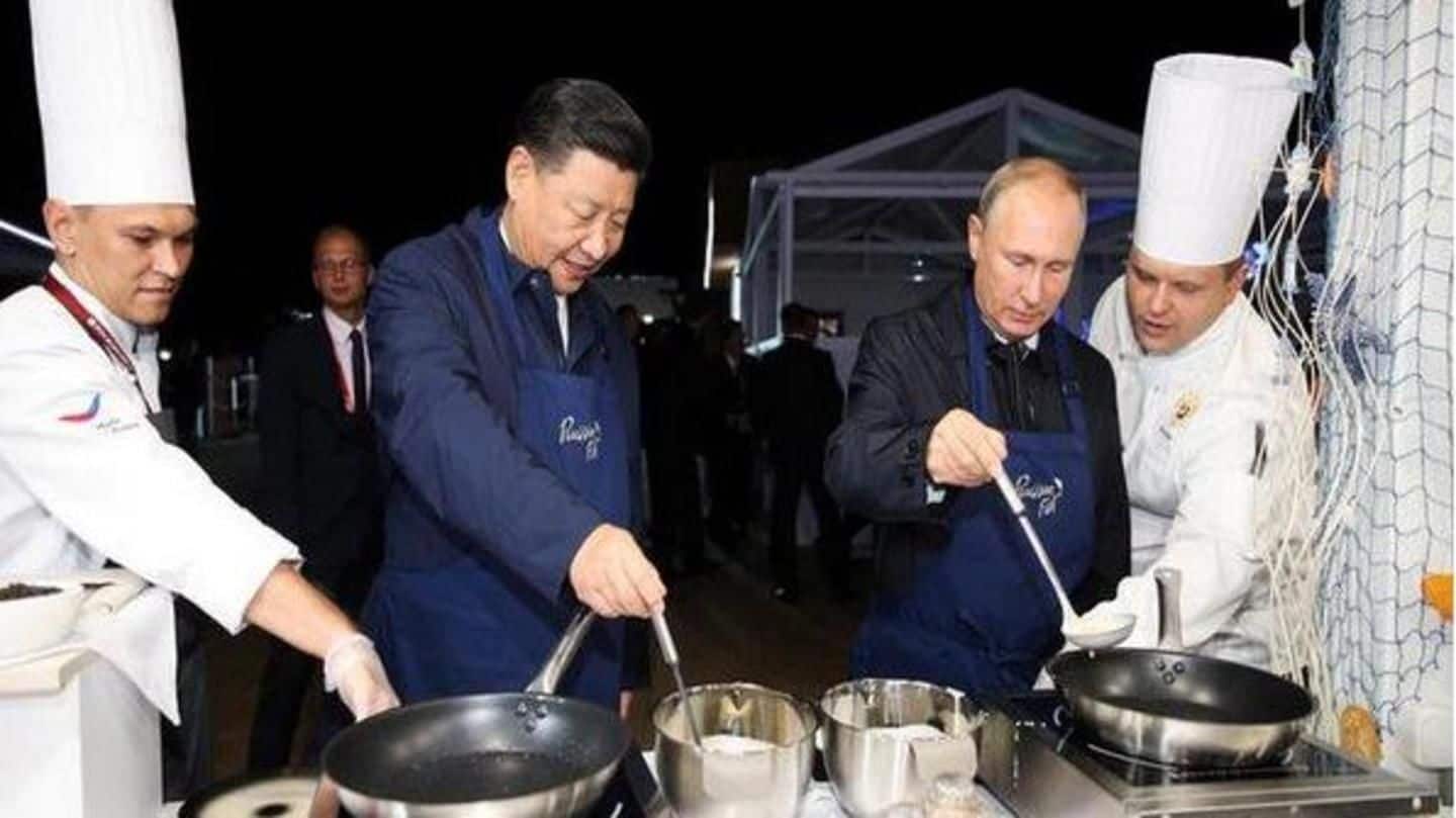 Russia's Putin and China's Jinping flip pancakes during economic forum