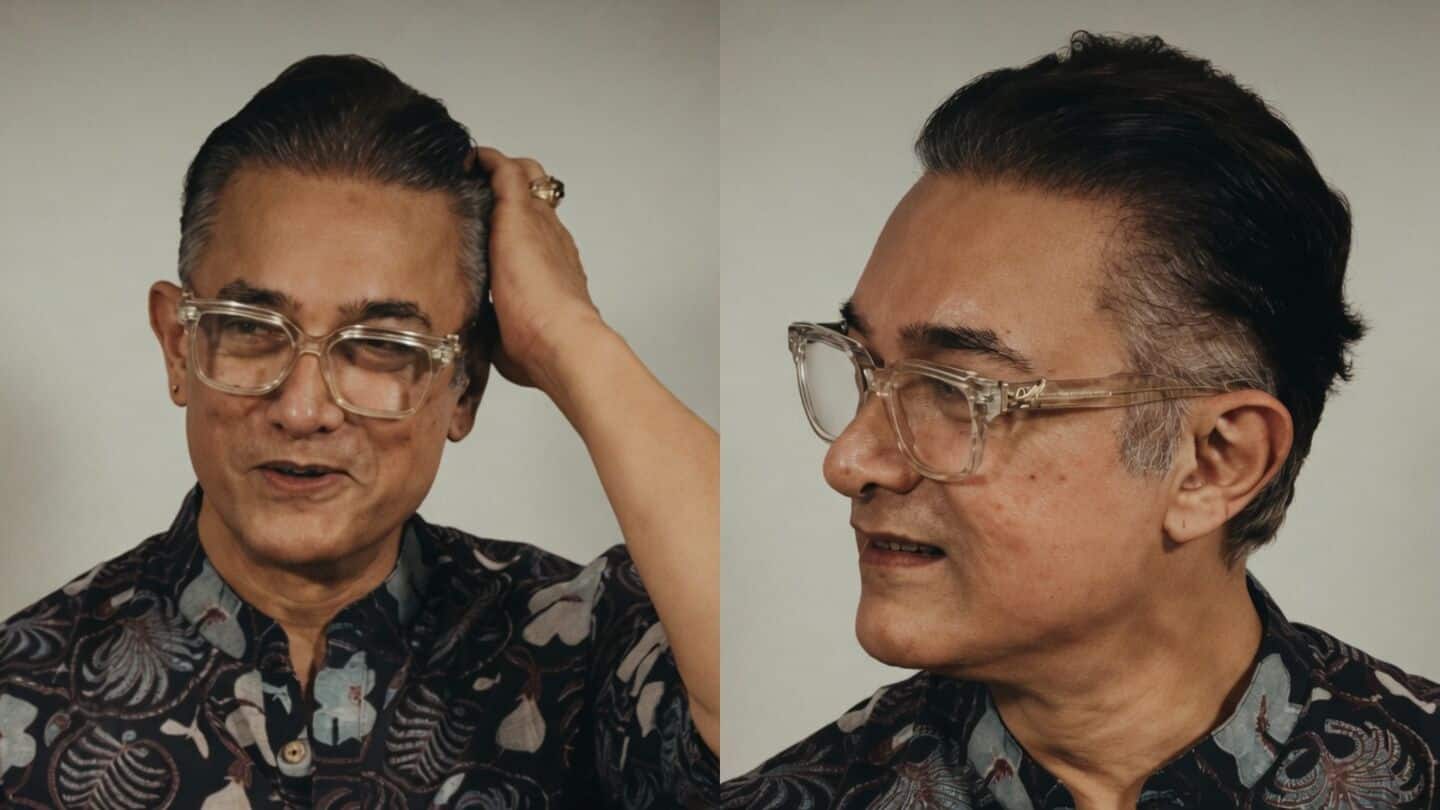 Khan sports natural salt and pepper hair at Mumbai festival