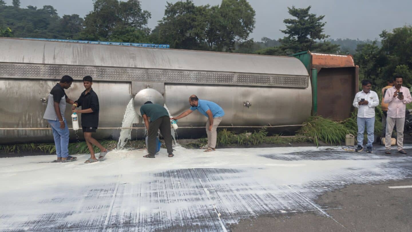 Locals collect spilled milk after tanker overturned on Mumbai-Ahmedabad highway