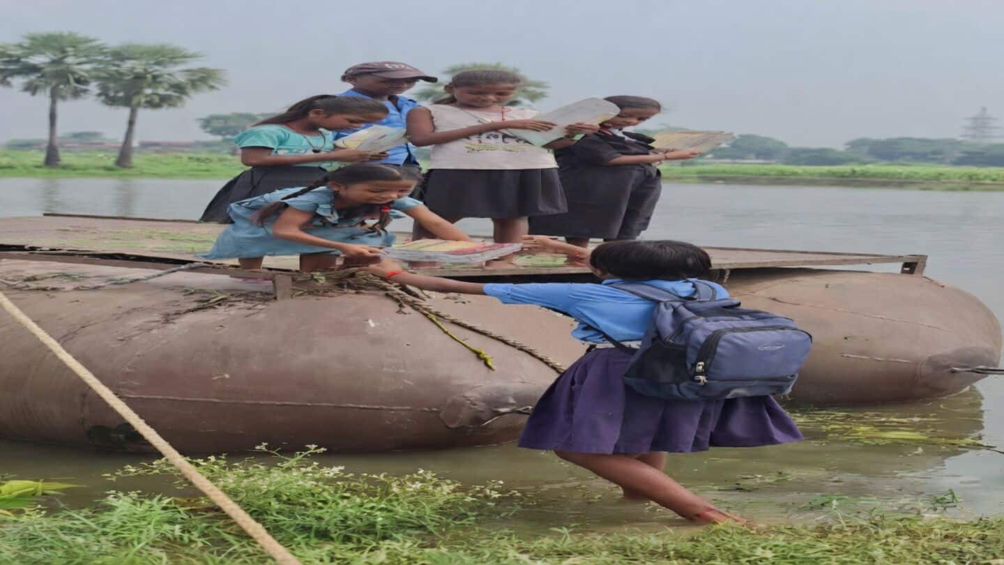 Children in Barh cross flooded river to reach primary school