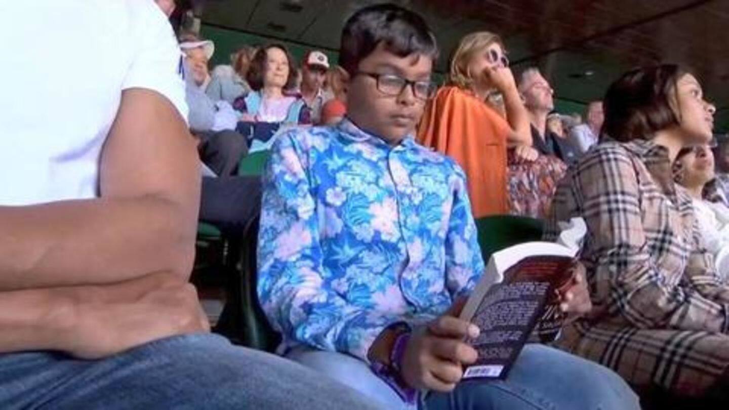 A young boy spotted reading book during the tie A young boy spotted reading book during the tie