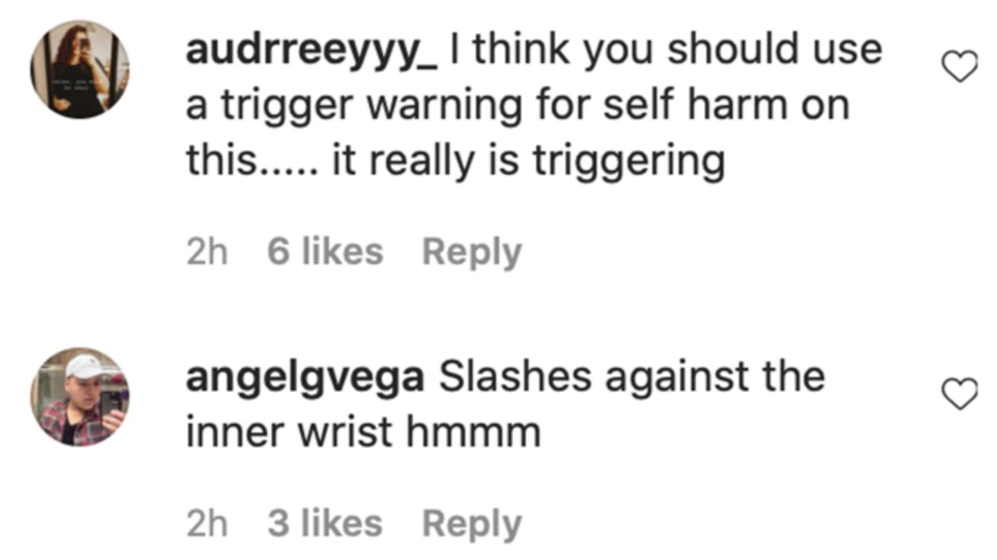 Model slashes inner wrist with eyeliner Model slashes inner wrist with eyeliner