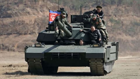 Kim Jong-Un oversees drill showcasing new tank with his daughter