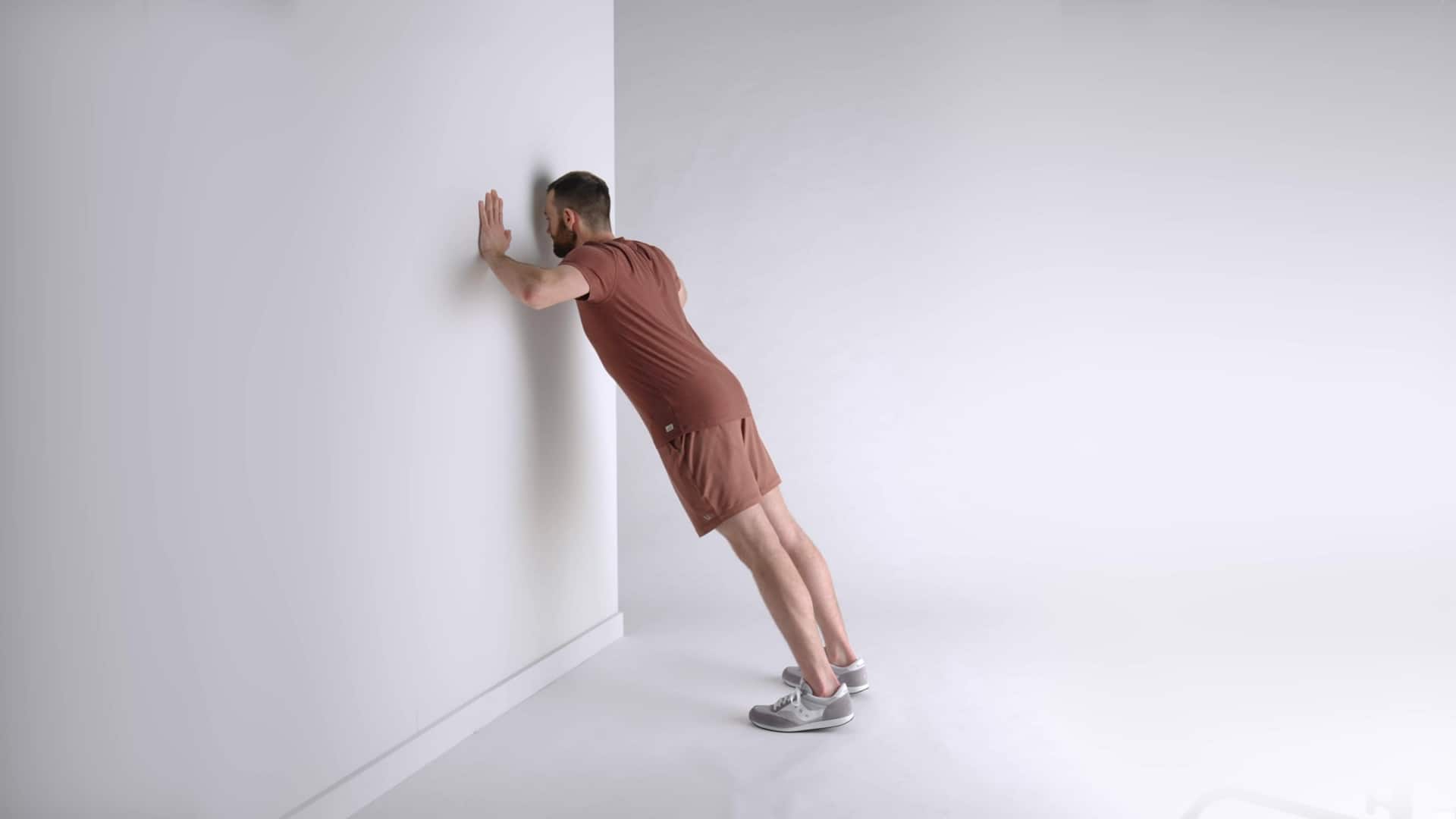 How to perform single-arm wall push-ups
