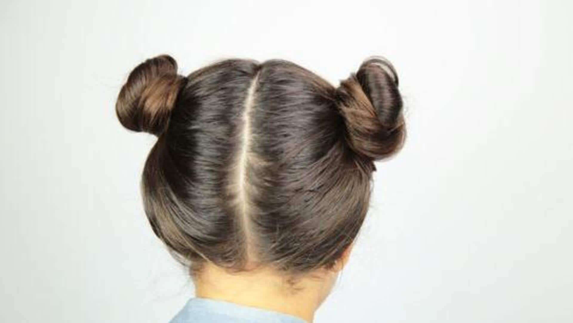 Whimsical space buns for mid-length curly hair