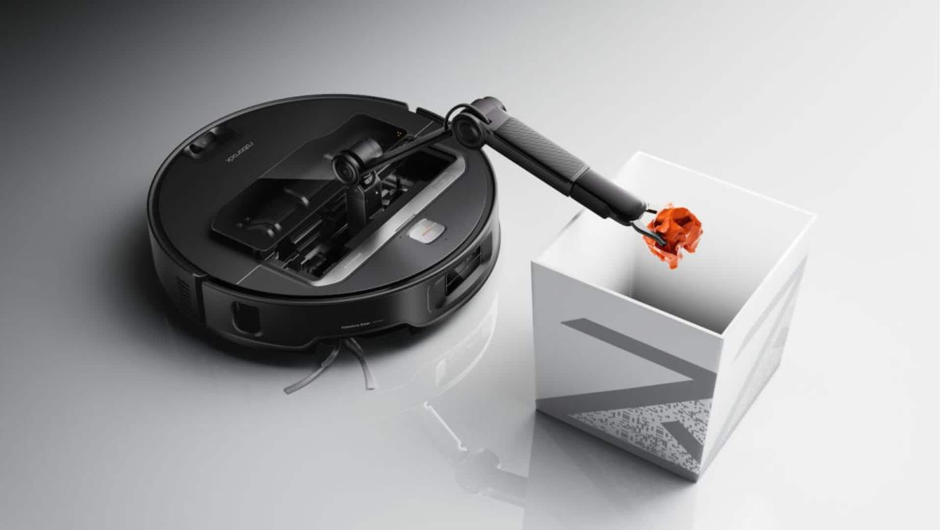 This robot vacuum cleaner has an arm to grab objects