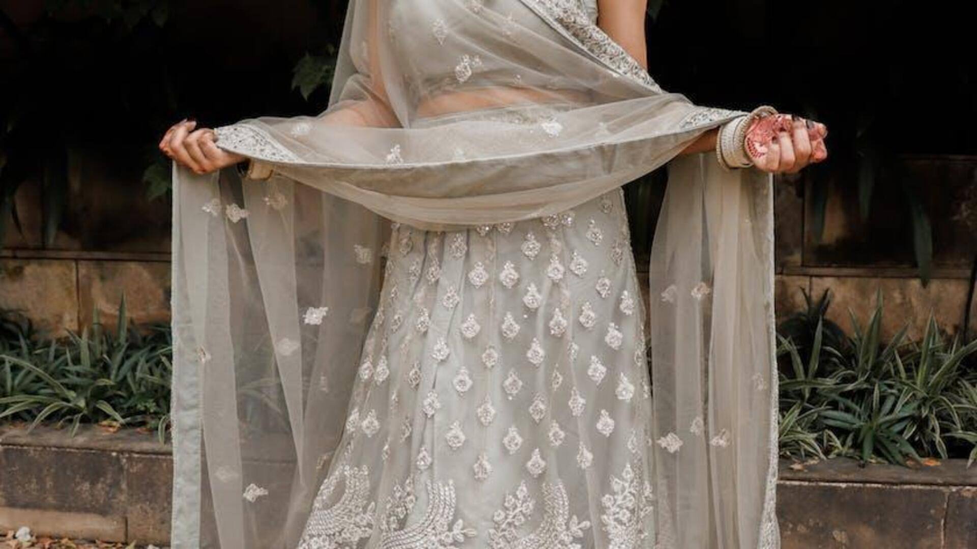 Silver tissue skirt paired with hand embroidered blouse & heavy jhal dupatta  – Arpita Mehta Official