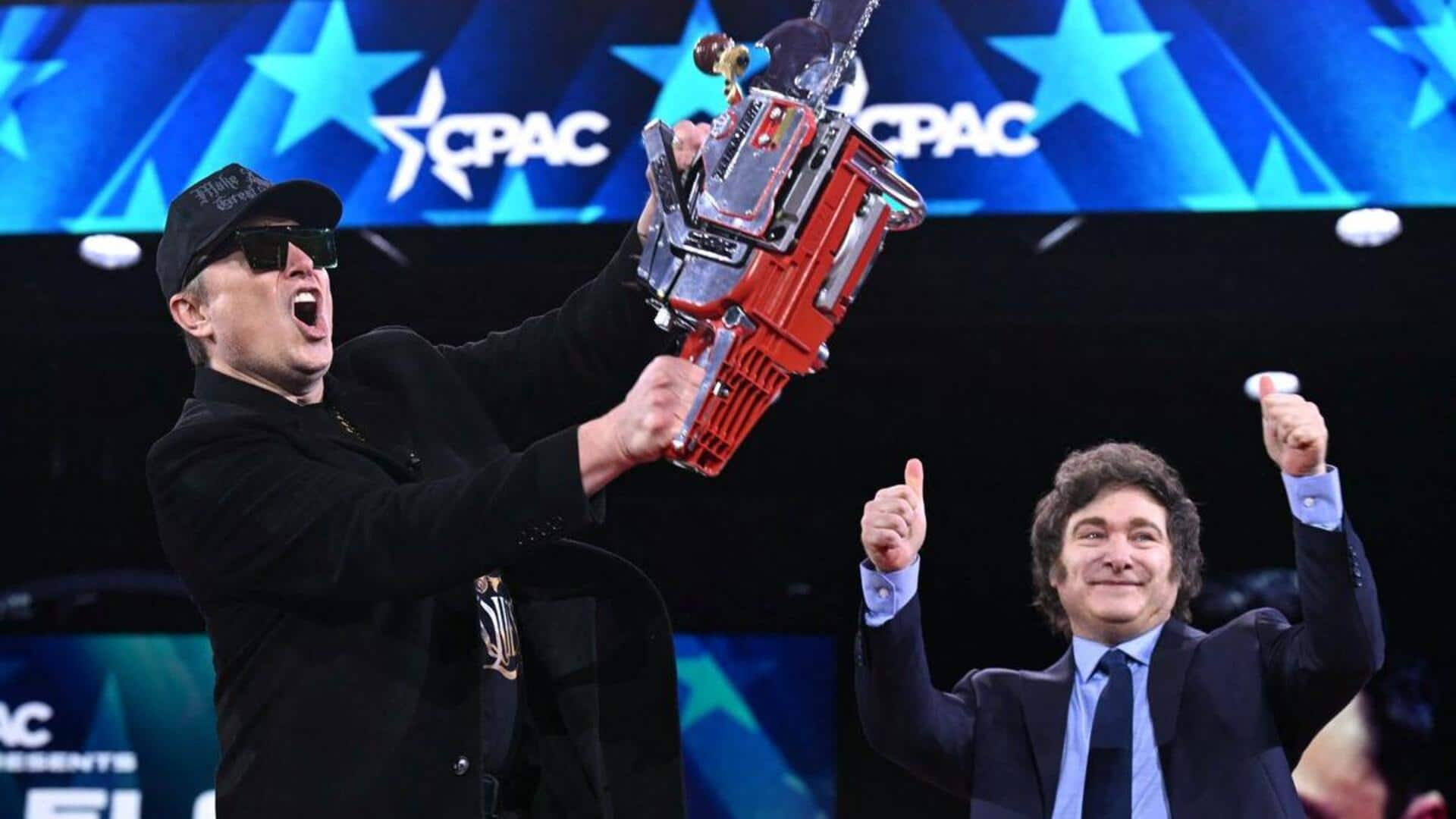 Musk waves chainsaw on stage, touting cuts to government spending 