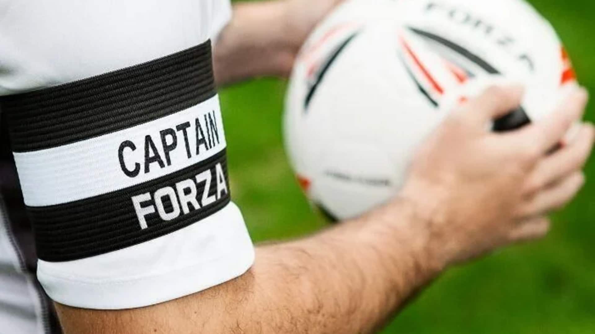 Mengapa kapten tim memakai ban lengan?